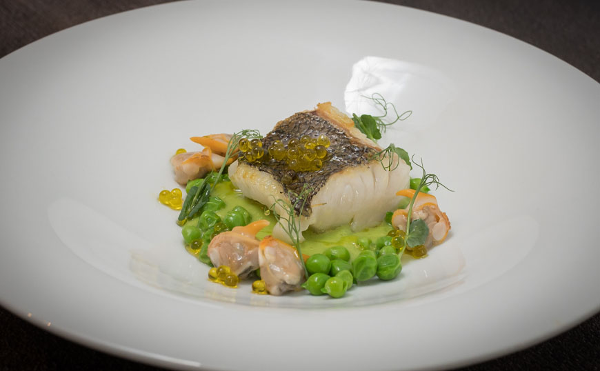 Hake with peas, cockles and evoo caviar